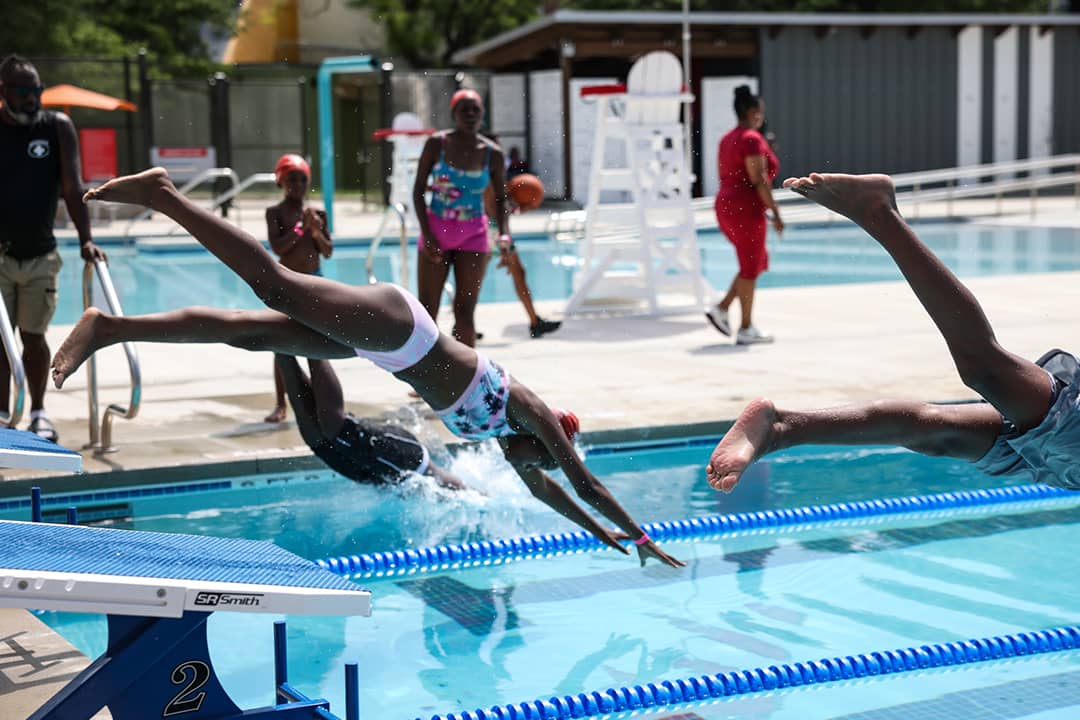 Children diving into a pool